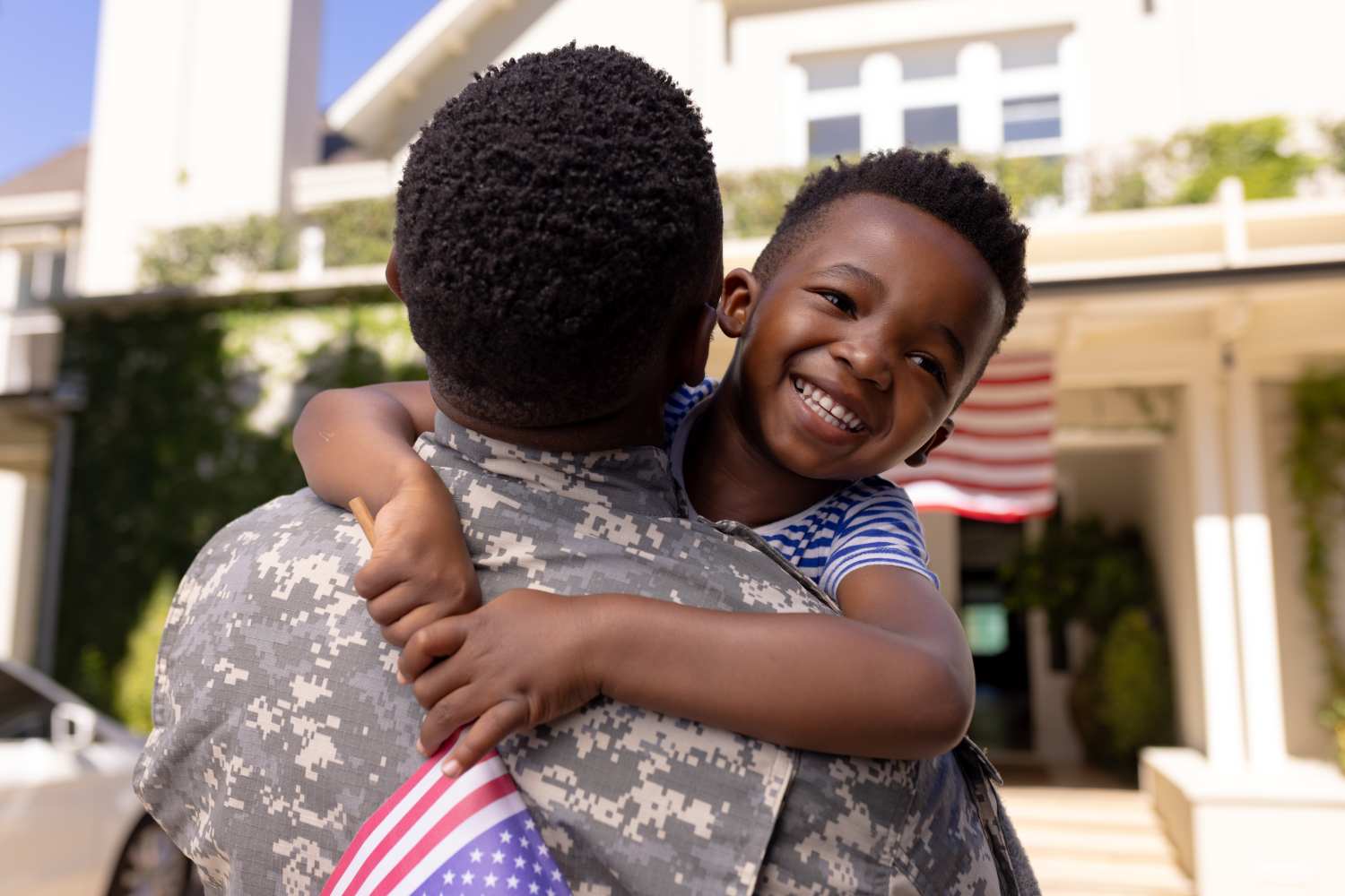Military father hugging his young son