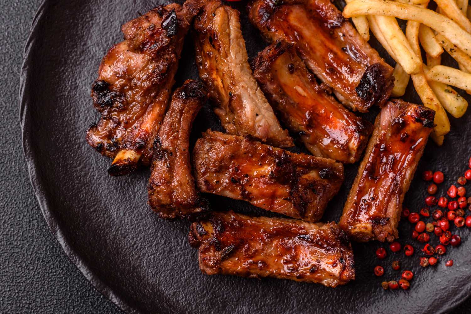 Marinated ribs and fries on a plate