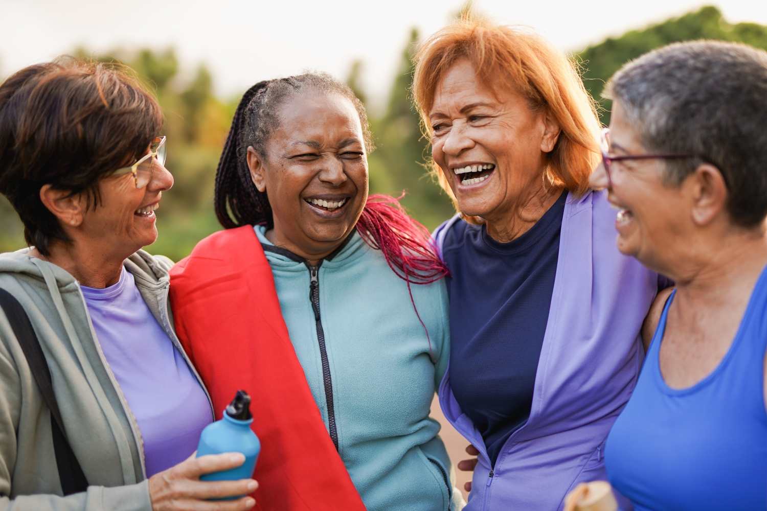 Four senior women laughing